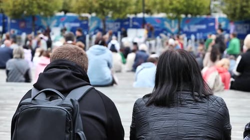People Sitting Outdoors in a Public Square Enjoying a Casual Urban Event