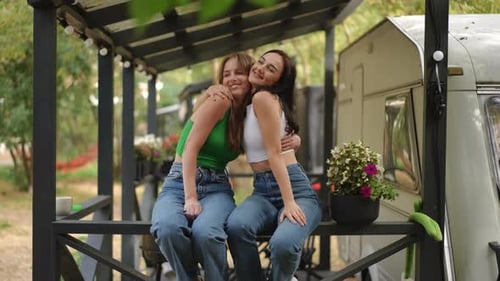 Two Young Women Embracing by Camper