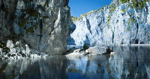 Serene Lake Surrounded By Beautiful Rocky Cliffs on a Sunny Day