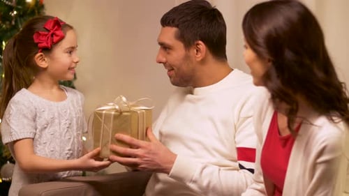 Family Giving Presents During Christmas Holiday at Home