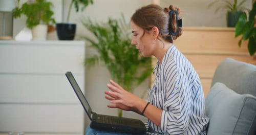 Woman Video Conferencing on Laptop in Home