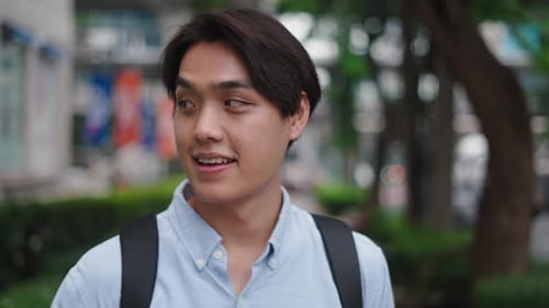 Young Asian Student Smiling and Drinking Coffee Outdoors