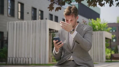 Stressed Businessman Reading Financial Market News Outdoors