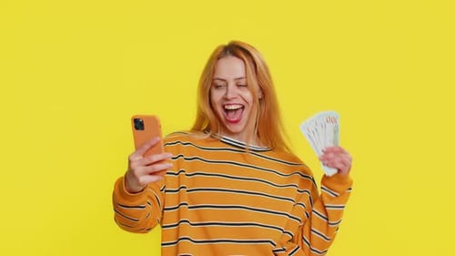 Woman Celebrates Financial Win with Smartphone
