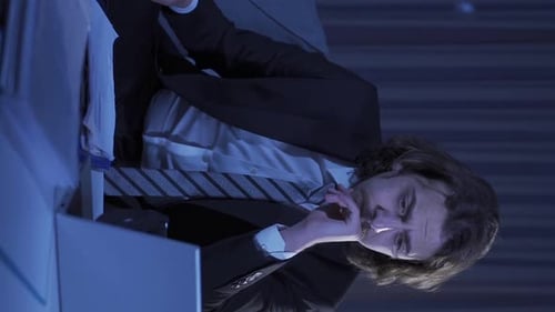 Stressed Man in Office at Night