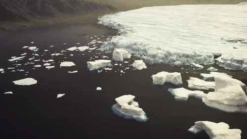 Broken Ice Fields Spread Across Shadowy Sea Environment Emphasizing Isolation