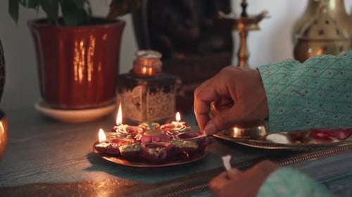 Person Lighting Candles on Decorated Table Indoors