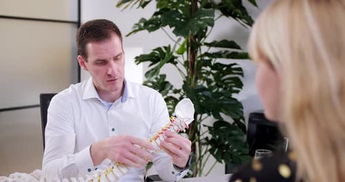 Doctor Explains Spine Anatomy To Female Patient