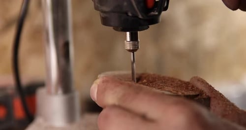Carpenter Working on the Drill Machine in His Workshop