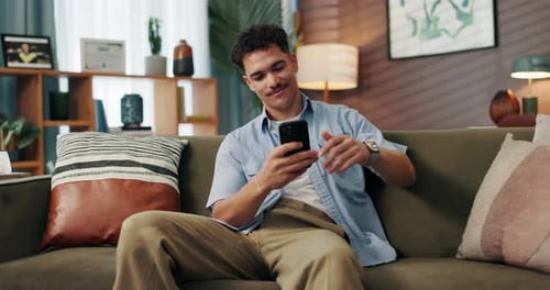 Sofa, man and smile with smartphone for communication, reading message and text from online contact
