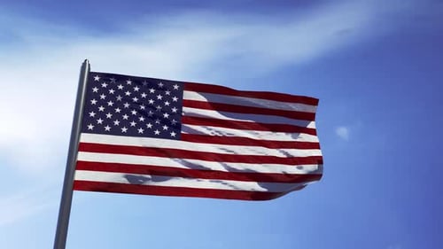 Waving American Flag Against Clear Blue Sky