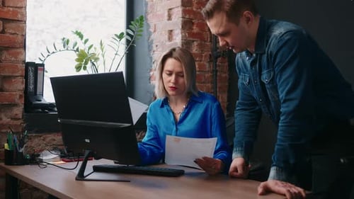 Boss And Employee In Office Female Director Of Company Checking Report Of Sale Specialist