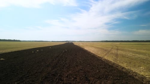 Tractors plowing the field in Ukraine