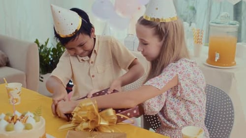 Children Opening Gifts at Fun Birthday Party