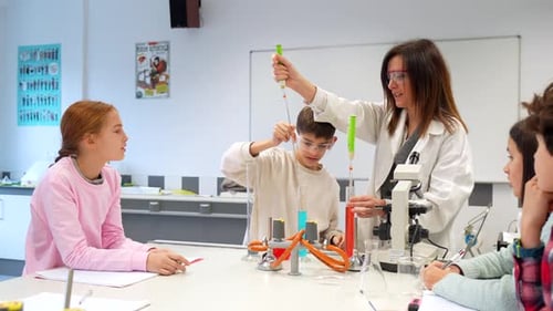 Students performing chemistry experiment in school laboratory