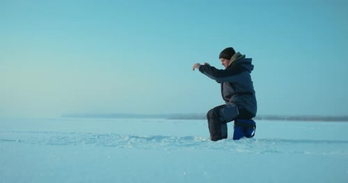Fisherman Catching Fish in Ice Hole in Sunny Winter Day Man Sitting on Tackle Box Prores