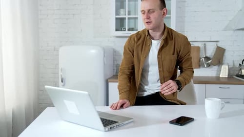 Young man freelancer using laptop. Businessman working on laptop from home office
