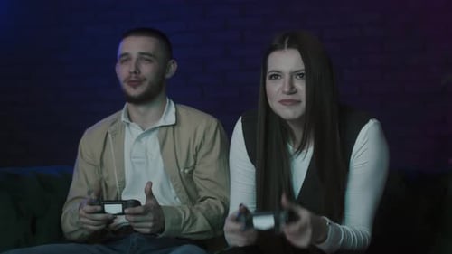 Man and Woman Play Video Games Indoors