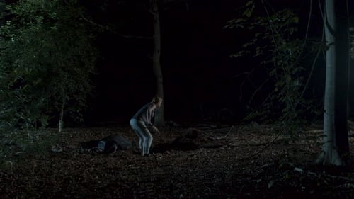 Woman digging a shallow grave next to a dead body in a spooky forest at night