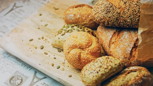 Artisan Bread Rolls and Loaf on Board