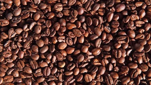 Coffee Beans Background Texture of Coffee Beans Close Up Dark Brown Roasted Coffee is Spinning