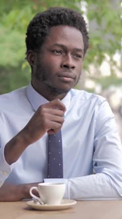Headache, Stressed African Businessman Sitting in Outdoor Cafe, Vertical Video