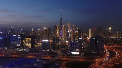 Aerial view of illuminated Dubai skyline at night, United Arab Emirates.