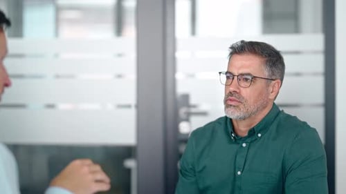 Business Meeting with Handshake Agreement in Modern Office