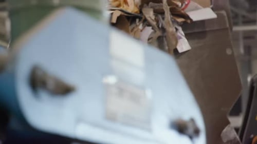 Excavator or Loader Bucket Scoops Up A Pile Of Cardboard Waste In Recycling Factory