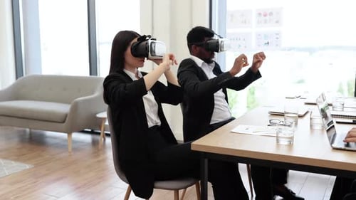 Business Professionals Using Virtual Reality Technology in Modern Office