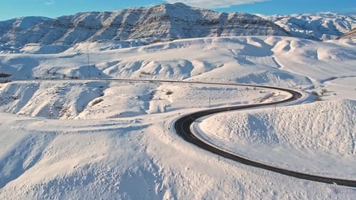 Curving Mountain Road Through Snow
