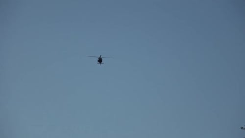 Helicopter Flying in the Blue Daytime Sky