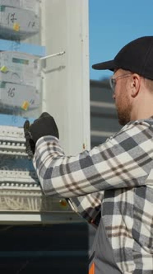 Electrician Working on Outdoor Power Box