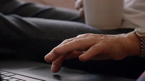 Mature Woman Using Laptop Trackpad 50s