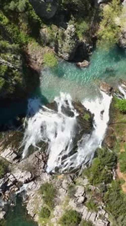 Aerial View of Waterfall in Lush Green Nature