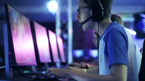 Serious Young Men Play Computer Games at Tournament