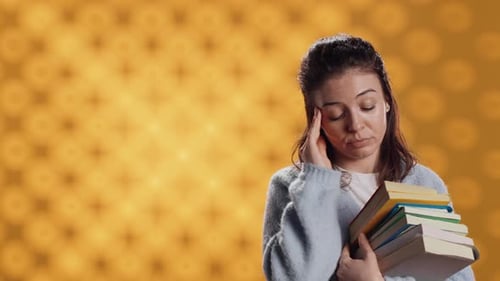 Woman Feeling Migraine Pain From Textbooks Needed for Homework