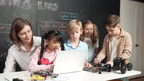 Teacher and Children Working on Robotics Project Together
