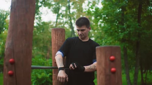 Man Preparing Workout Focused Athlete in Urban Park Performing Calisthenics Warmup Determined Man