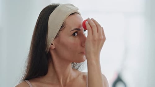 Beauty Girl Applying Foundation Indoors Close Up Lady Using Cosmetics Sponge