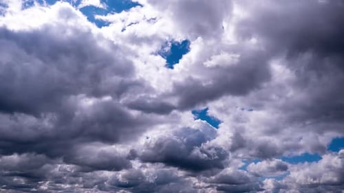 Timelapse of Cumulus Dark Clouds Moving in the Blue Sky