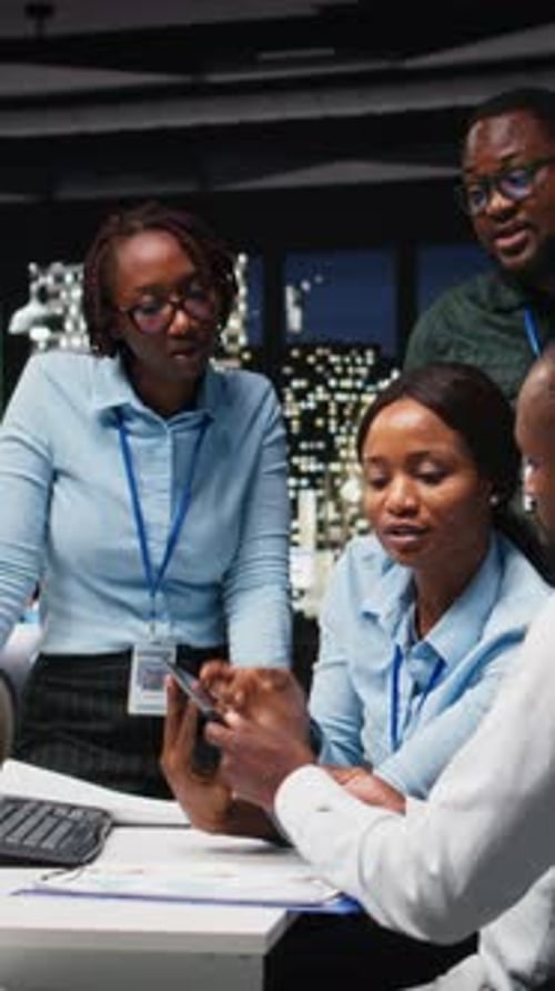 Vertical Video Black Company Employees Reviewing Data Finances in an Office Meeting