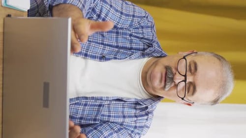 Mature Man Engaged in Video Conference