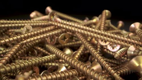 CloseUp View of Gold Screws in a Pile