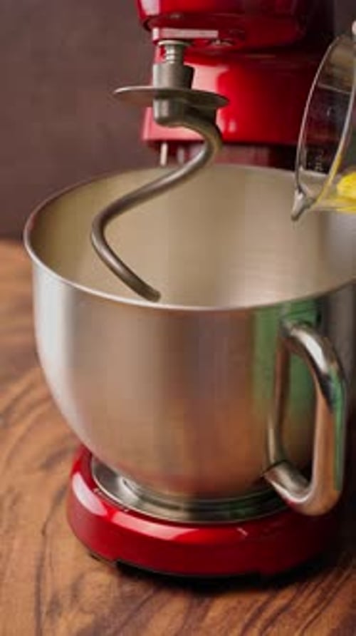 Vertical Food Video, Stand Mixer, Adding Eggs With A Glass Measuring Cup