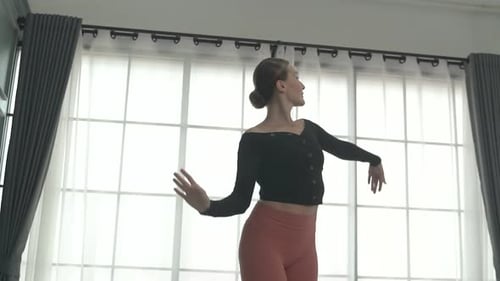 Friends practice ballet dance at studio.