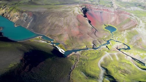 Aerial view of a sulphurous green lake with craters and lakes in Iceland highlands.