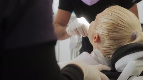 A Young Woman in the Dentist's Office in the Process of Dental Treatment