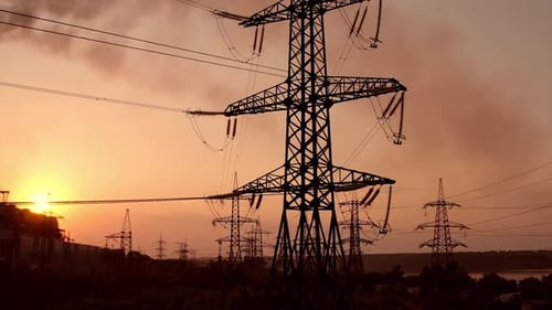 Electricity tower with wires at sunset.
