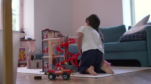 Children Playing with Toy Garage and Cars in Home